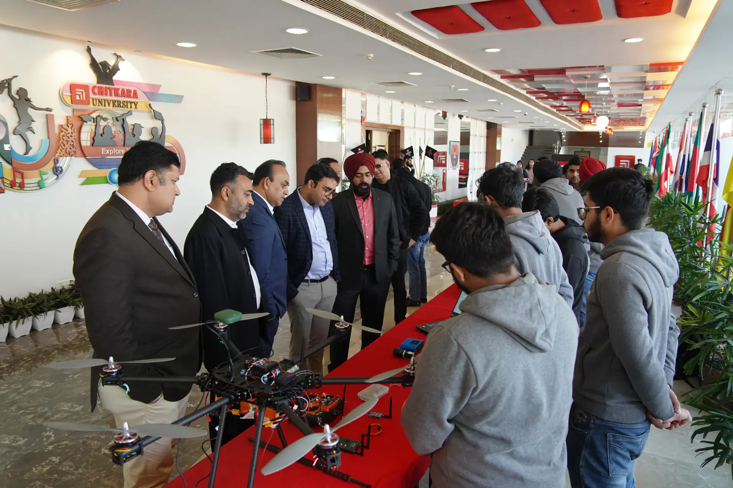 Guests examining a student-built drone