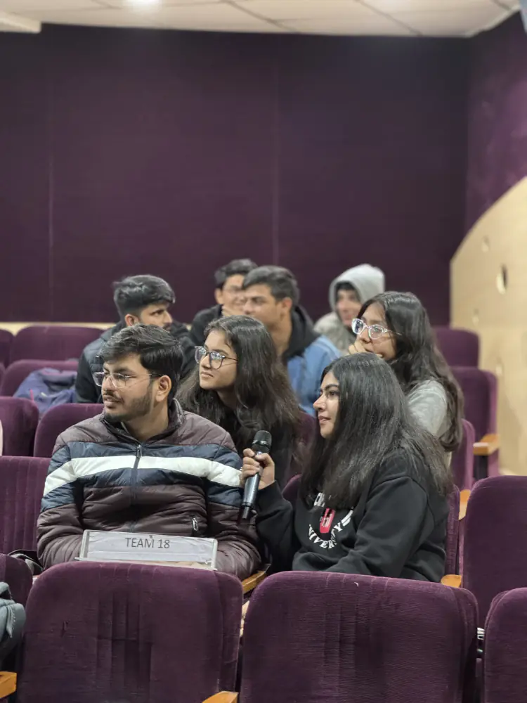 A student asking a question in the auditorium
